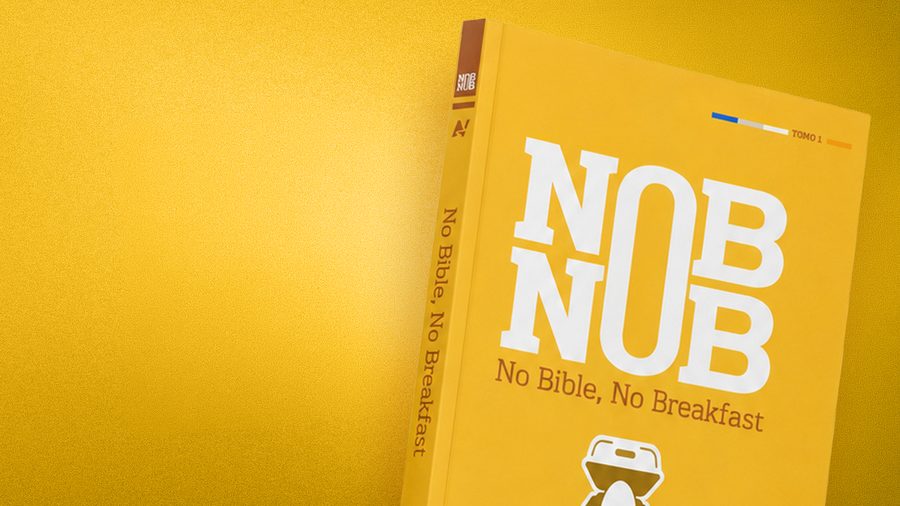 The printed No Bible, No Breakfast devotional standing against a yellow background